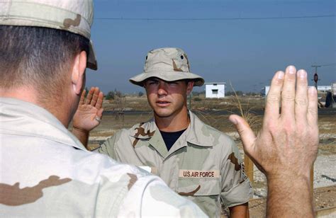 An Unidentified Us Air Force Usaf Officer Foreground Administer The Oath Of Reenlistment To Usaf Senior Airman Sra Dave Cantwell Contract Escort 438Th Expeditionary Civil Engineering Flight While Deployed At A Forward Location In Support Of An Unidentified Us Air Force Usaf Officer Foreground Administer The Oath Of Reenlistment To Usaf Senior Airman Sra Dave Cantwell Contract Escort 438Th Expeditionary Civil Engineering Flight While Deployed At A Forward Location In Support Of